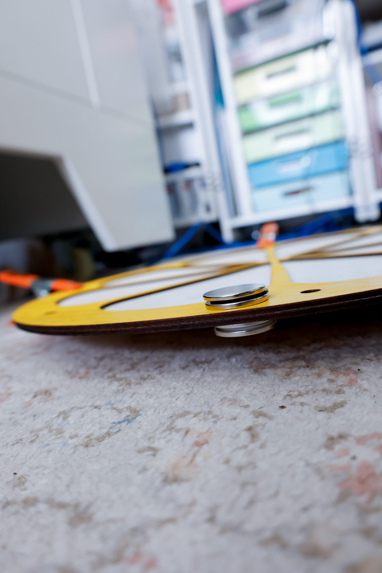 behind the scenes photo showing clamps and magnets holding wood pieces together for stability